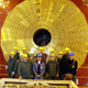 Russian scientists standing in front of the brass endcap at CERN’s CMS experiment.